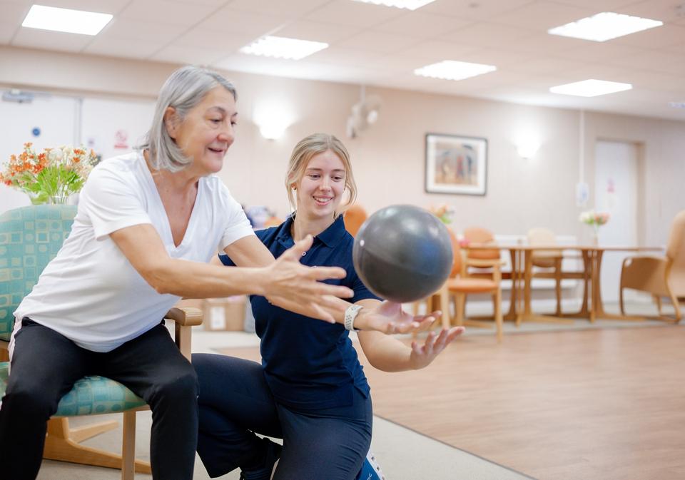 Seated ball exercise with a physiotherapist
